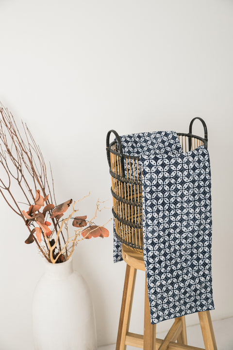 geometric design table cloth presented in a brown black wicker basket
