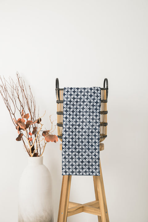 geometric design table cloth presented in a wicker basket